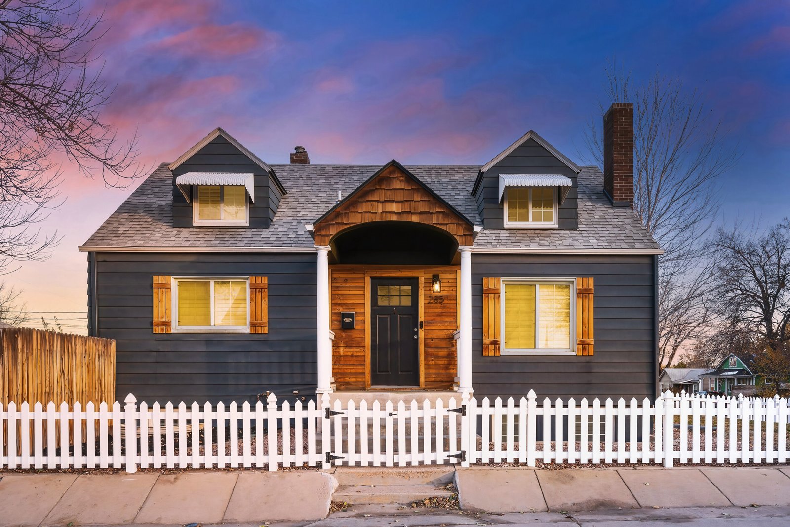 Denver Real Estate Photographer explores a 1929 single-family home at 285 E Dartmouth Ave, Englewood, CO, featuring a landscaped corner lot, white picket fence, and stunning twilight sky. Modern updates blend seamlessly with vintage details in this cozy 3-bedroom, 3-bathroom property.