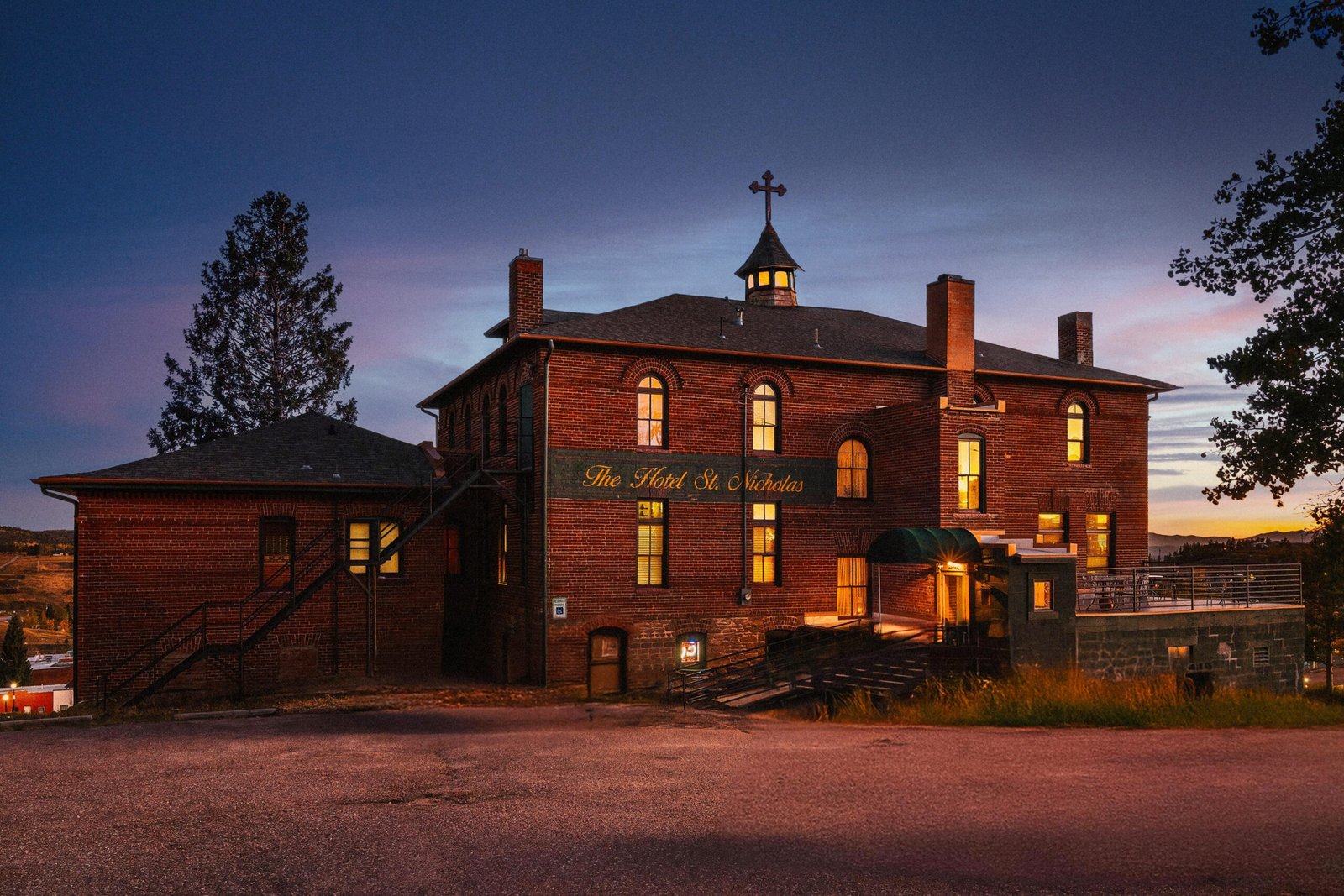 Denver hotel photographer captures hotels in Cripple Creek like St. Nicholas Hotel using drone photography at twilight, showcasing historic charm and haunting elegance.